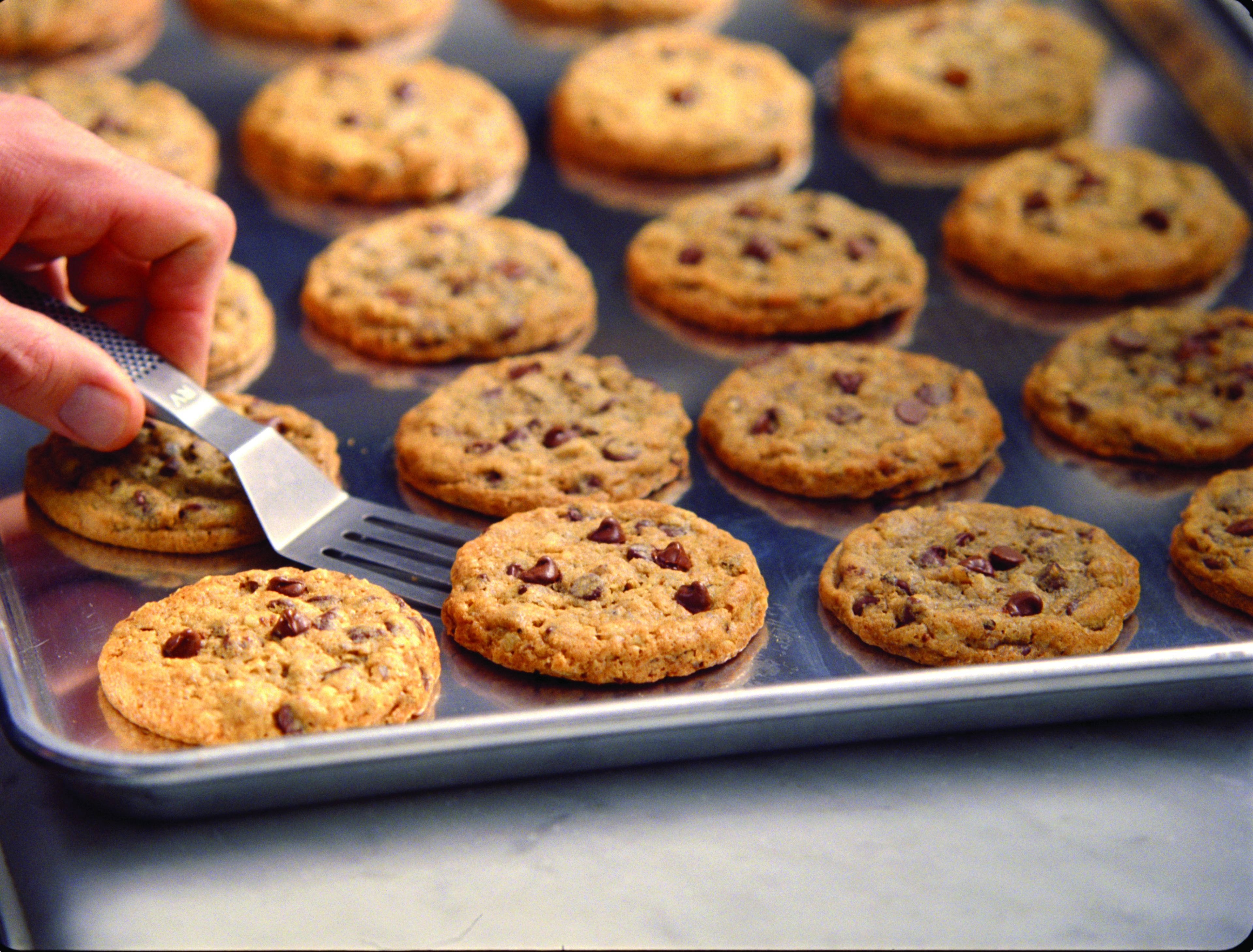A tray of freshly baked cookies on a metal baking sheet.