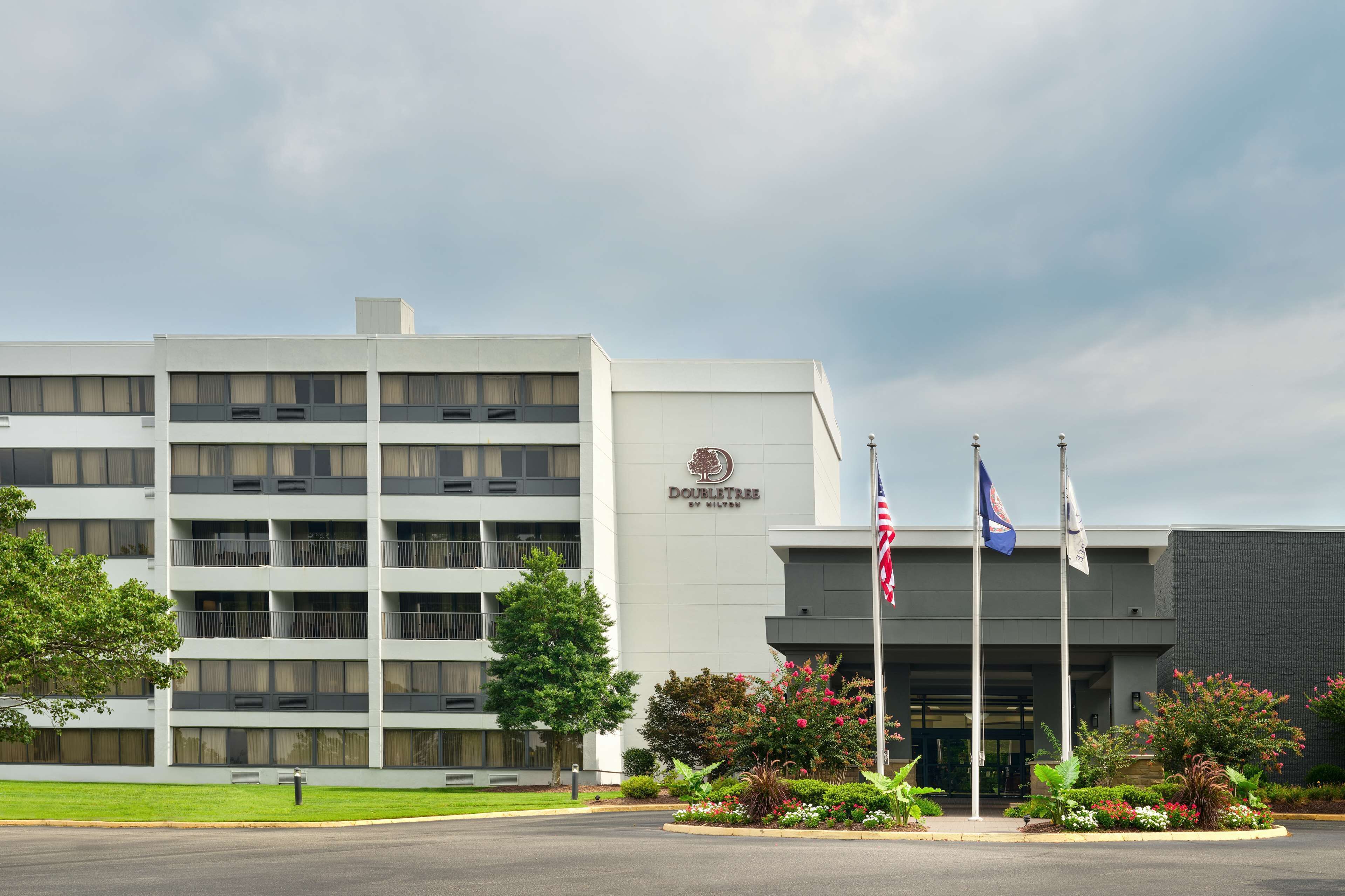A modern building with a sign reading "Doubletree by Hilton".