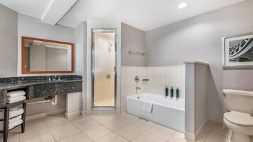A modern bathroom with a shower, bathtub, and toilet.