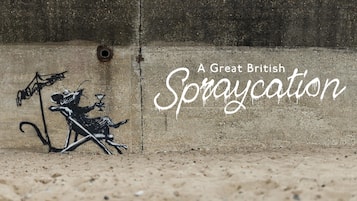 Pared de concreto con grafitis y el texto 'A Great British Spraycation'.