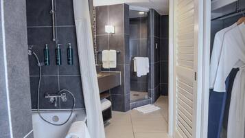 A modern bathroom with a bathtub, shower, and vanity.