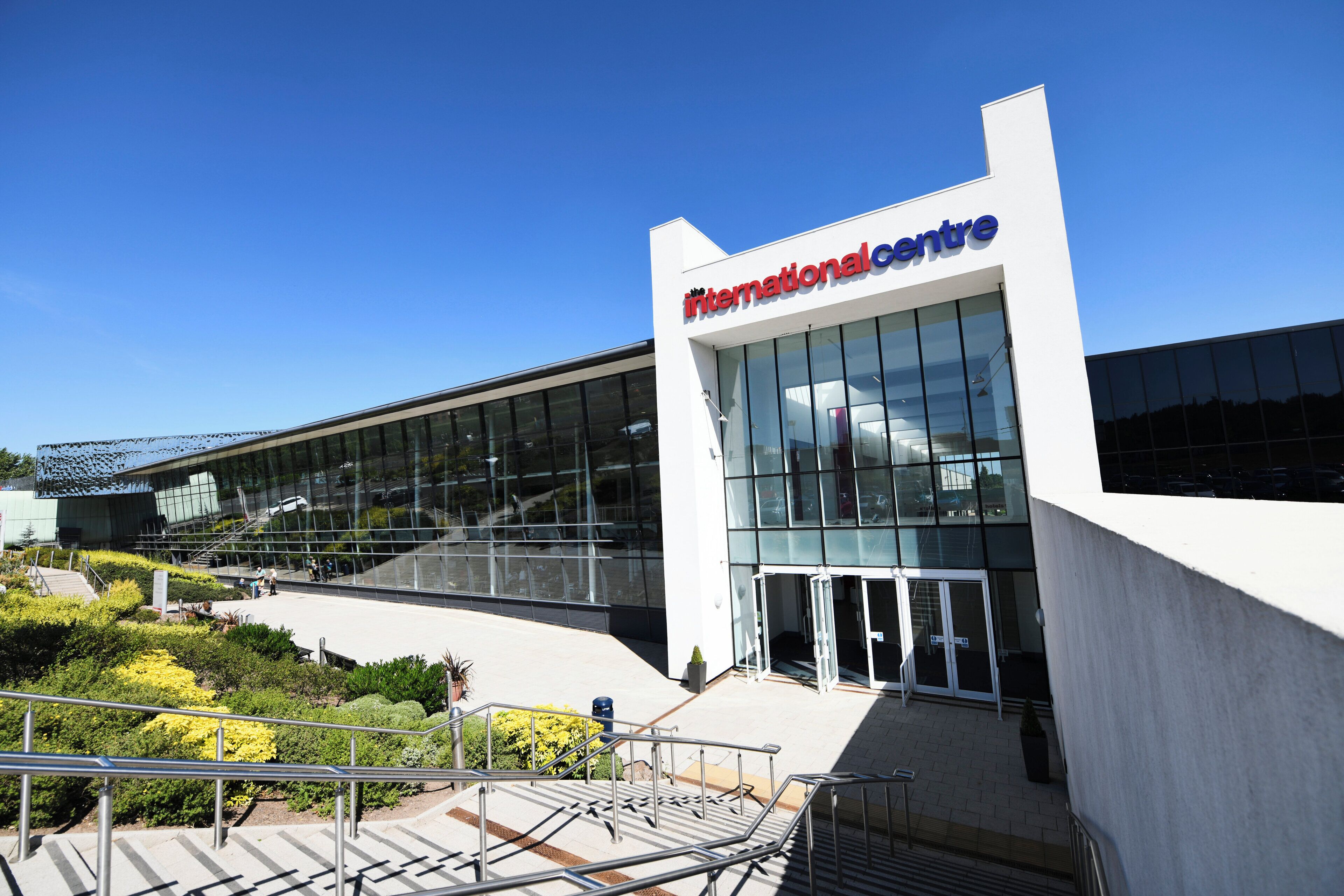 A modern building with a glass facade and a sign reading 'International Centre.'