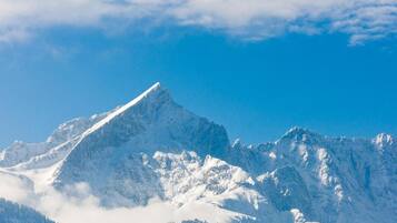 A snow-covered mountain peak with a clear sky.