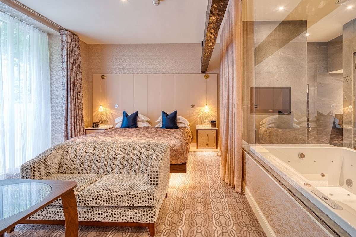 luxury double room | in-room safe, desk, blackout curtains, iron/ironing board