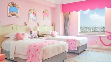 A pink-themed bedroom with two beds, a city view, and Hello Kitty decorations.