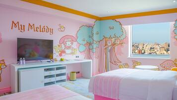 A child's bedroom with a city view, a TV, and a desk with storage drawers.