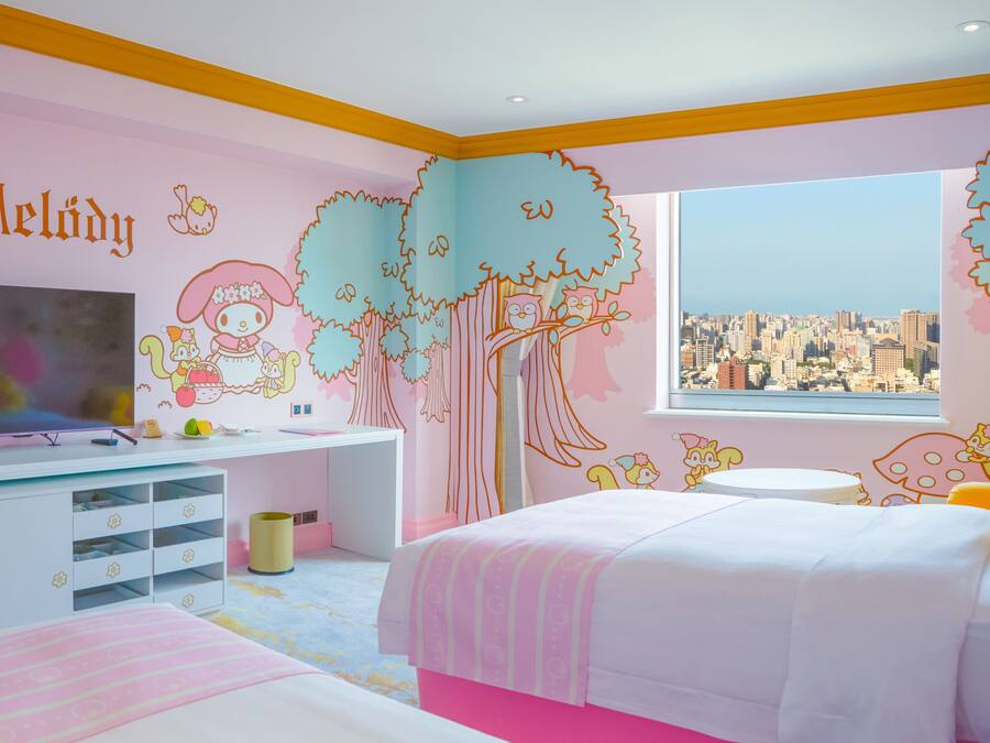 A child's bedroom with a city view, a TV, and a desk with storage drawers.