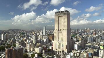 A high-rise building with a classic architectural style, surrounded by a dense urban environment with numerous other buildings.