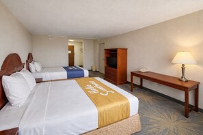 A hotel room with two beds, a wooden desk, a lamp, and a television. - Days Inn by Wyndham Sidney OH (Sidney)