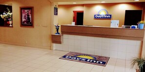 A reception area with a reception desk, a framed picture on the wall, and a 'Days Inn' sign above the desk. - Days Inn by Wyndham Sidney OH (Sidney)
