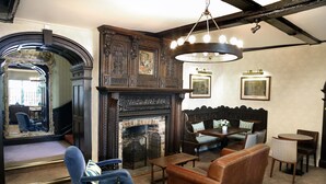 A traditional room with a fireplace, a large mirror, and a seating area with a sofa and chairs. - Best Western Red Lion Hotel (Salisbury)