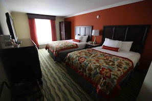 A hotel room with two beds, a desk, a chair, a TV, and a window with curtains. - Palm Beach Gardens & Suites Conference Ct (North Palm Beach)