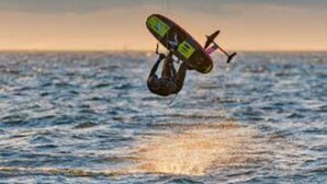 A person performing a trick on a wakeboard over water. - Palm Beach Gardens & Suites Conference Ct (North Palm Beach)