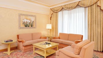 A room with two sofas, a coffee table, a lamp, and a painting on the wall.