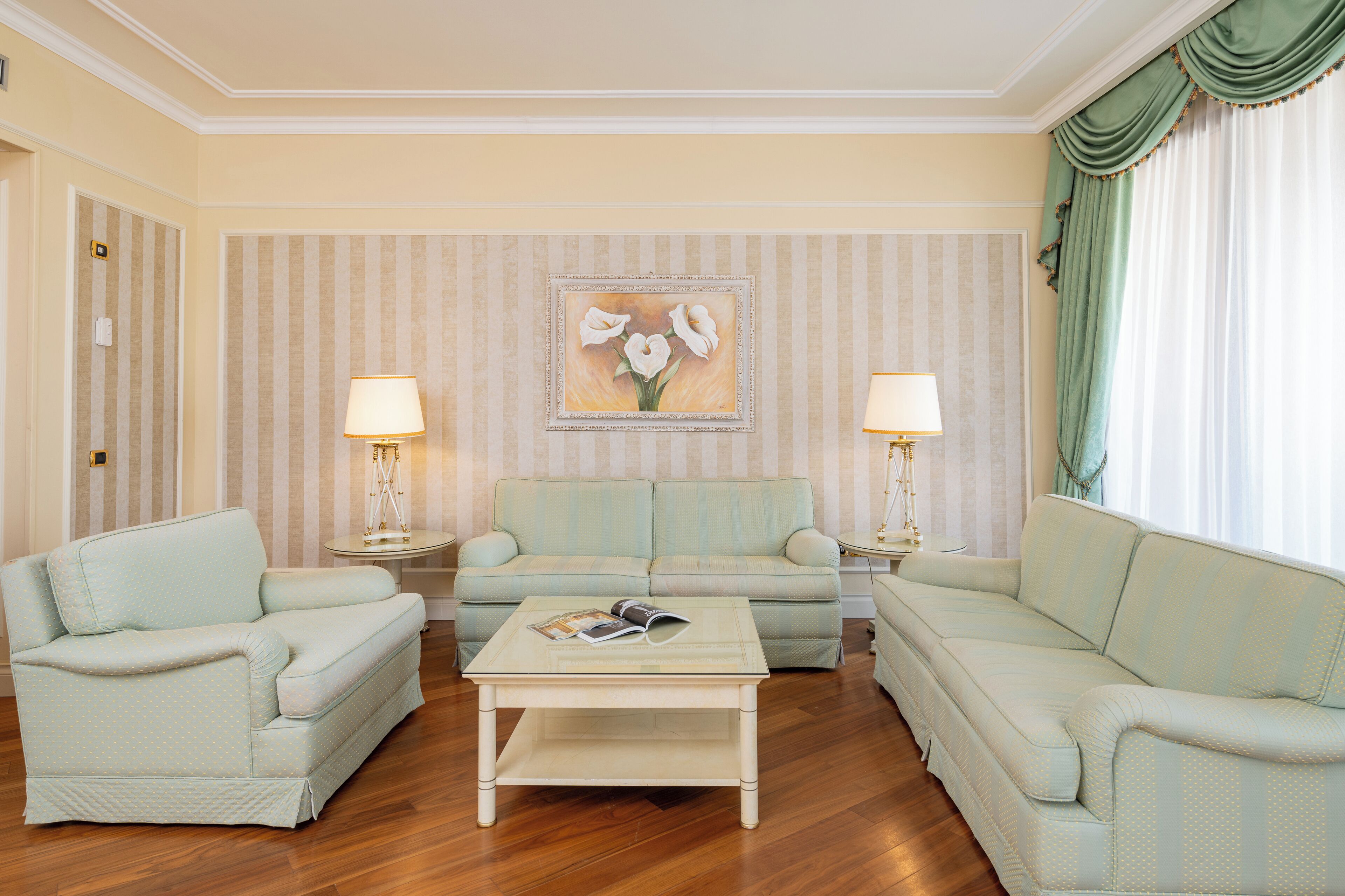 A living room with a sofa set, two side tables, and a coffee table.
