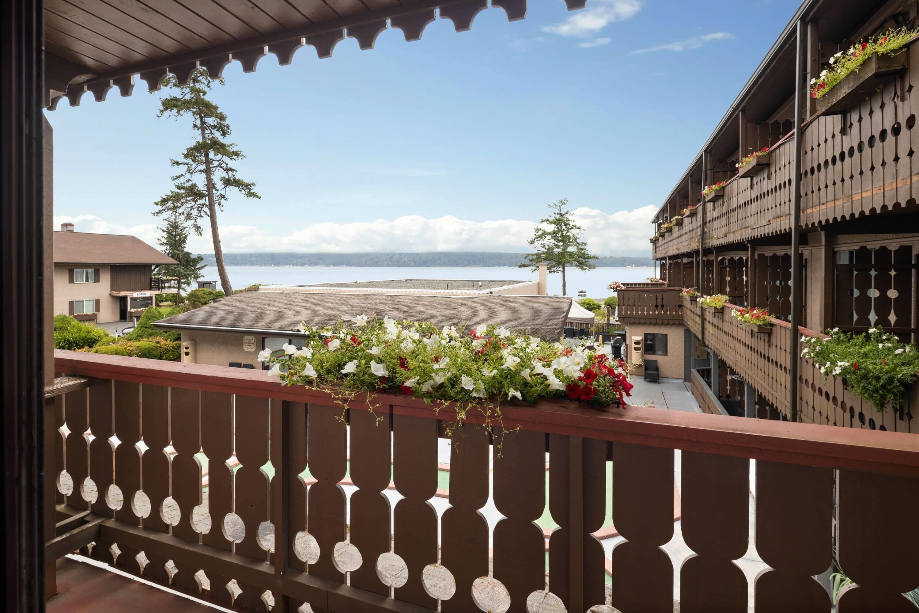 A balcony with a view of a body of water and buildings.