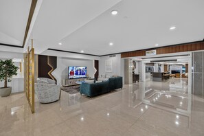 A modern interior with a flat-screen TV, seating area, and a bar/lounge area.