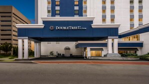 A hotel entrance with a prominent "DoubleTree by Hilton" sign, a covered walkway, and a large building in the background. - DoubleTree by Hilton Downtown Wilmington - Legal District (Wilmington)