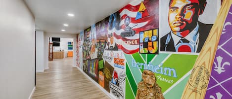Un pasillo con un mural que presenta varios logotipos e imágenes, incluyendo la Feria Estatal de Kentucky y Fort Knox.