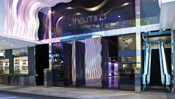 A modern building with a wavy facade and signage for 'the mira' in Hong Kong. - The Mira Hong Kong Hotel (Kowloon)