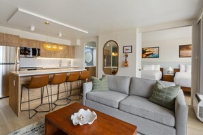 A modern living space with a kitchen, dining area, and a sofa set. - Aston at the Waikiki Banyan (Honolulu)