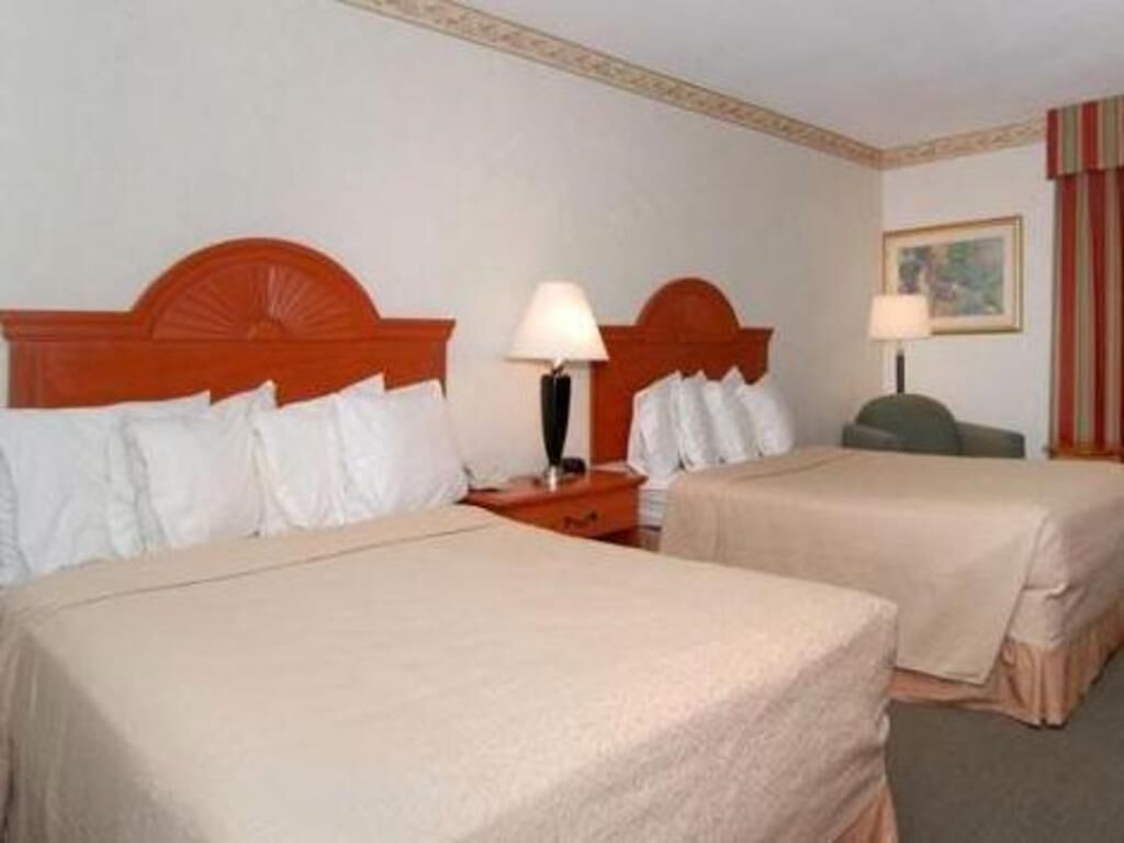 Premium bedding, desk, laptop workspace, blackout drapes