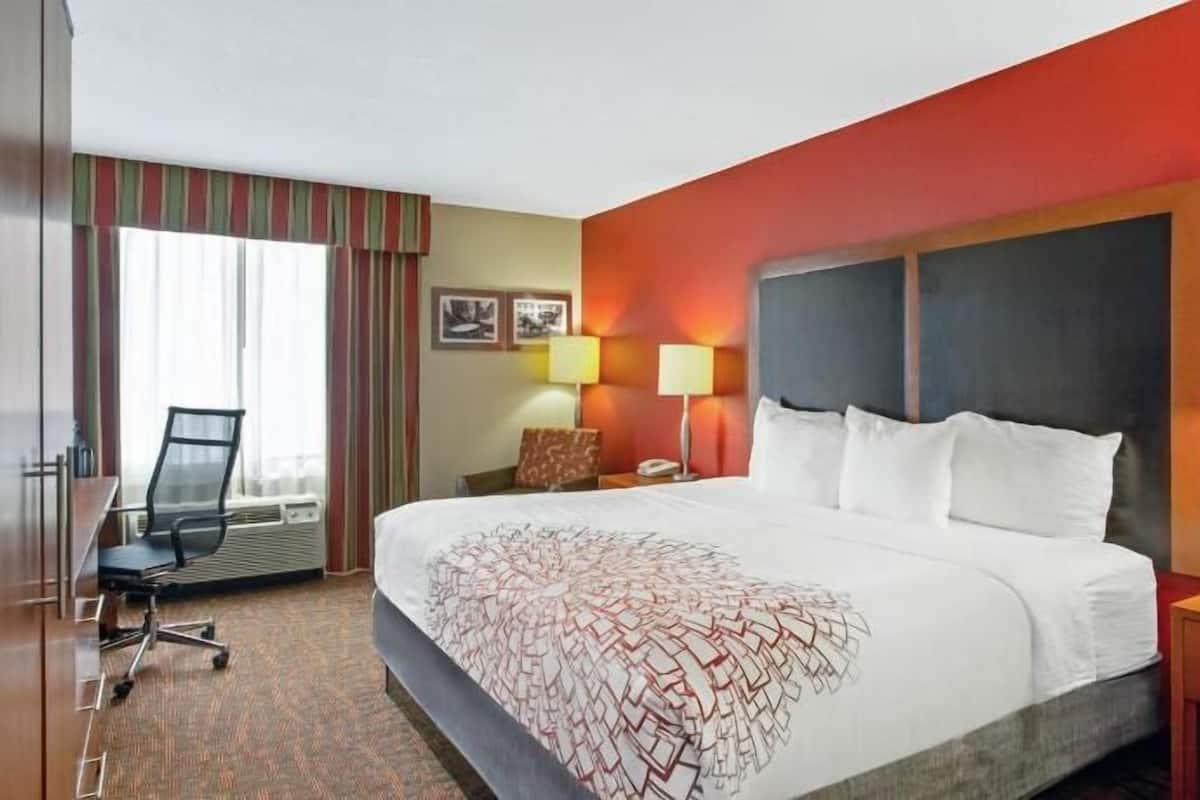 Premium bedding, desk, laptop workspace, blackout drapes