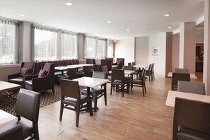 Relax in a spacious room with a seating area, large windows, and a comfortable layout.