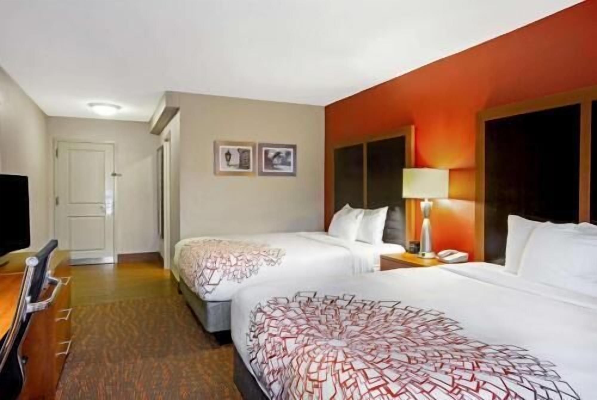 Premium bedding, desk, laptop workspace, blackout drapes