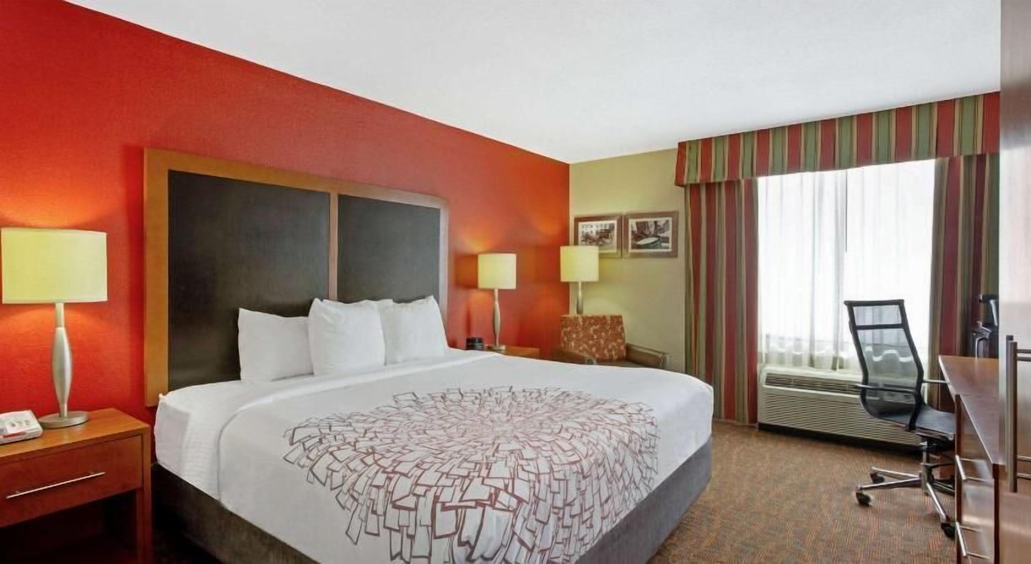 Premium bedding, desk, laptop workspace, blackout drapes