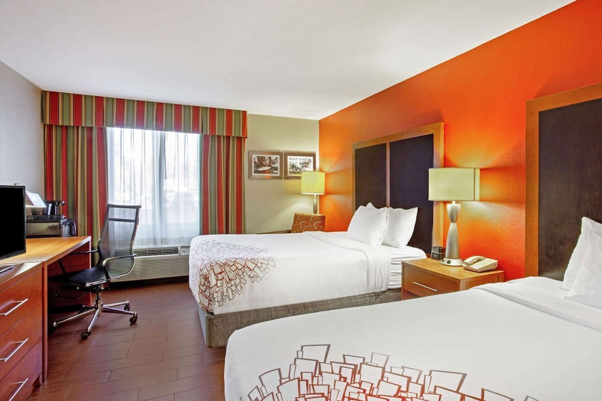 Premium bedding, desk, laptop workspace, blackout drapes