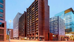 A Sheraton hotel with a modern design, featuring a prominent brick facade and multiple balconies. - Sheraton Ottawa Hotel (Ottawa)