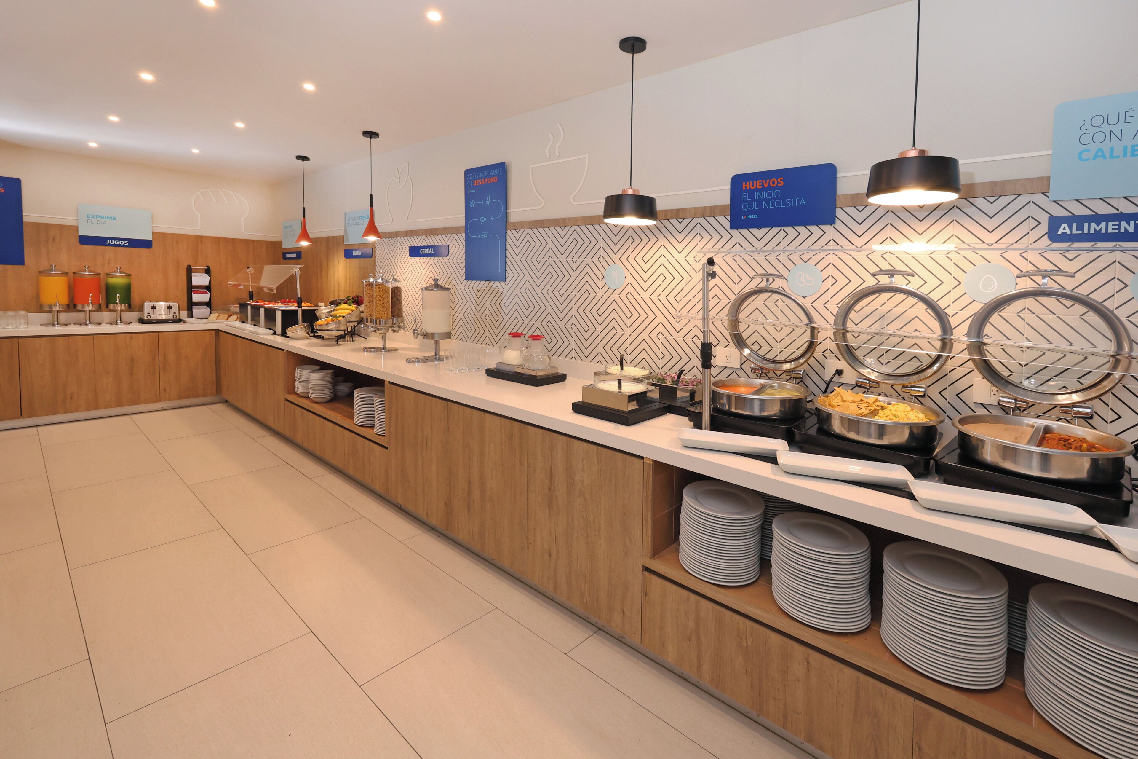 A buffet area with various food stations, a coffee machine, and a coffee urn.