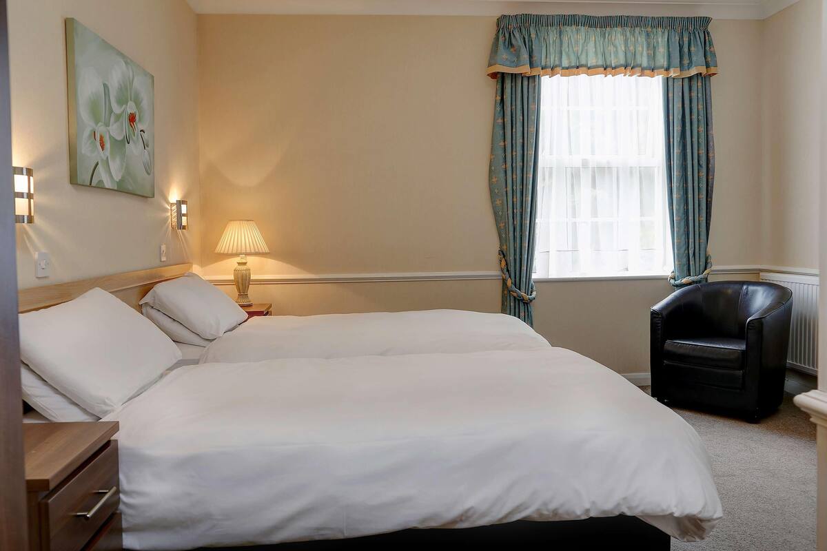 Premium bedding, desk, laptop workspace, iron/ironing board