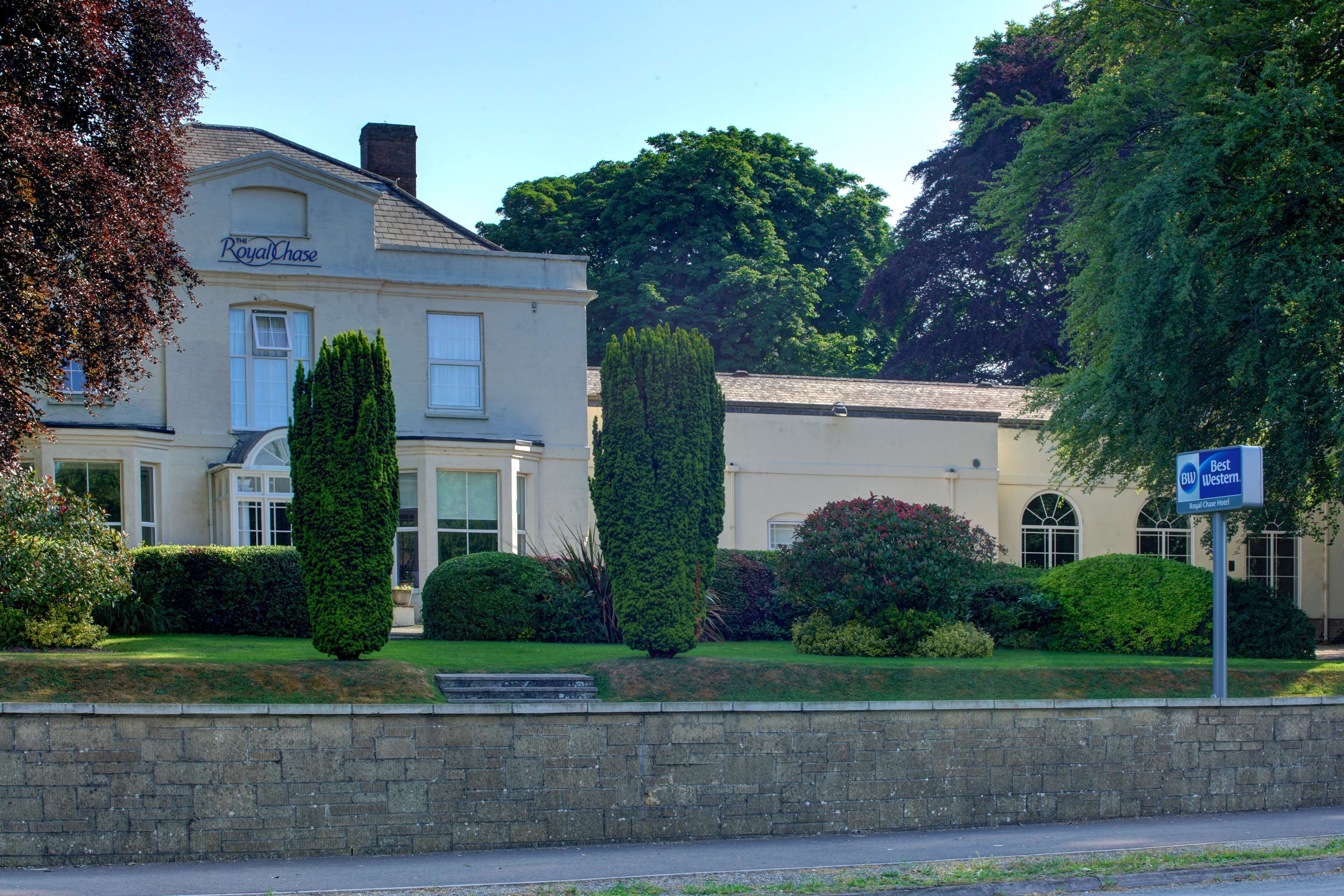 A two-story building with a sign reading "Royal Chase."