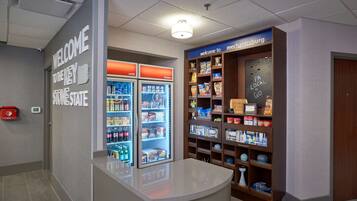 A reception area with a counter, a 'Welcome to the Key Stone State' sign, a 'Welcome to Mechanicsburg' sign, and a snack display.