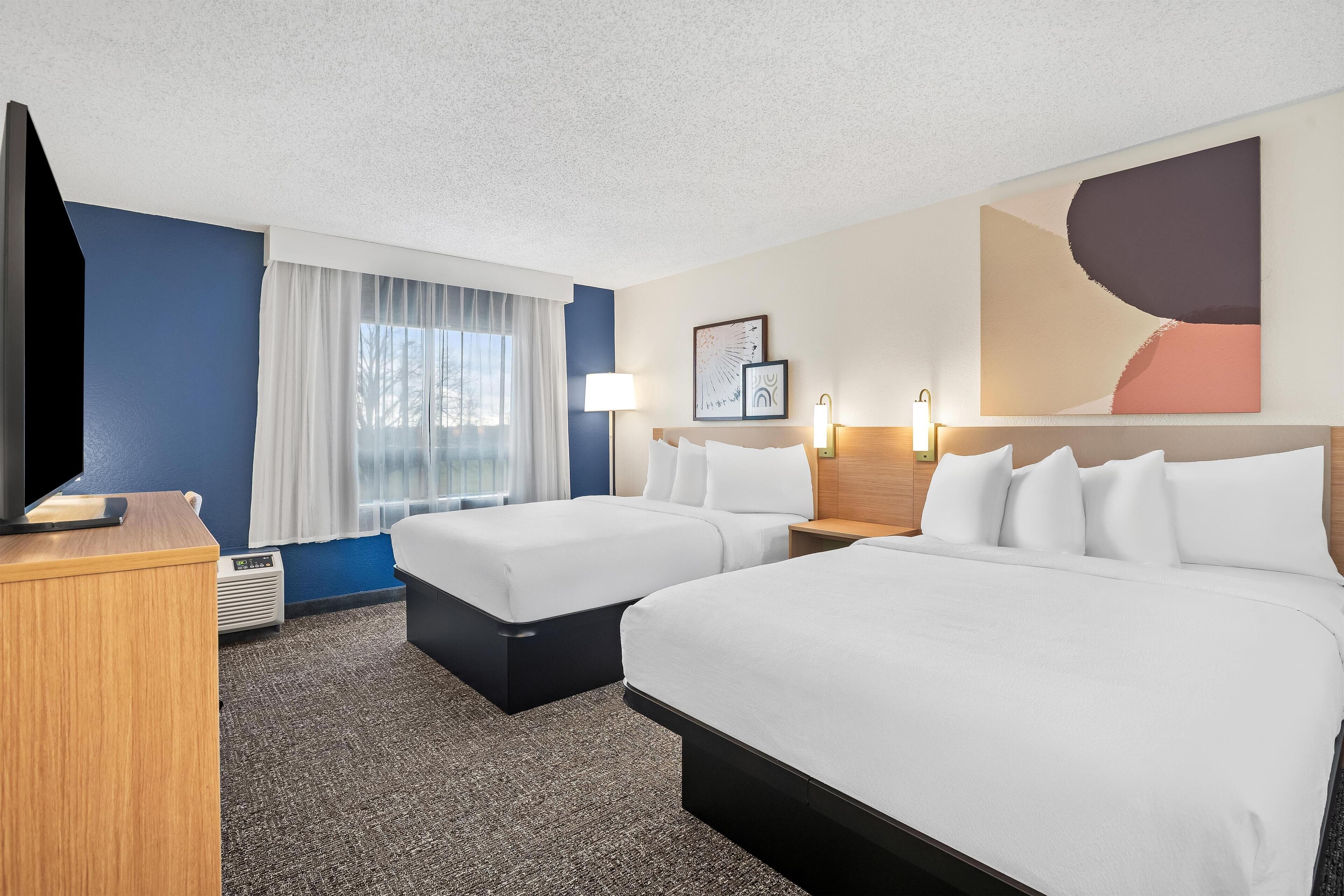 Espacio para trabajar con laptop y tabla de planchar con plancha 