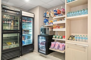 A refrigerated display area with various beverages and snacks.