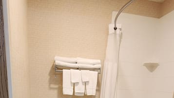 A bathroom with a toilet, a bathtub, and a shower.