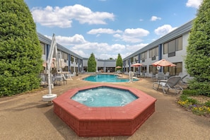 A hotel with two pools, a hot tub, and outdoor seating. - Best Western Plus Madison-Huntsville Hotel (Madison)