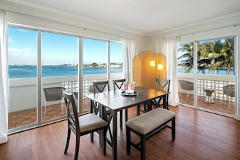 One Bedroom Bay View Suite King with Balcony | Dining room at Palm Tree Club Miami Hotel