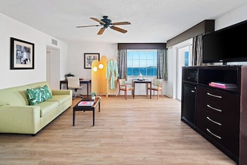 A modern kitchen with a central island, stainless steel appliances, and bar stools. at Palm Tree Club Miami Hotel