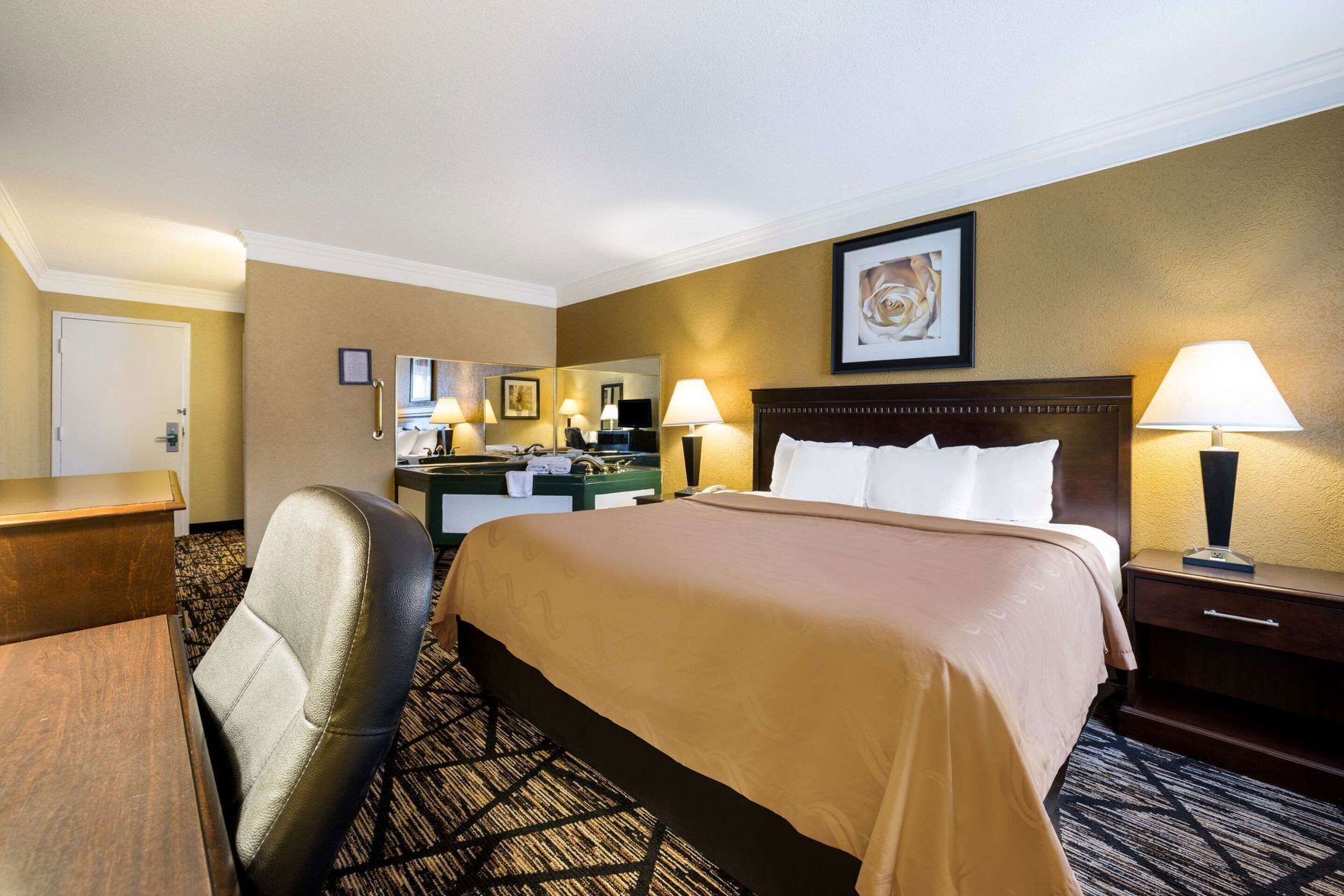 Premium bedding, desk, laptop workspace, iron/ironing board