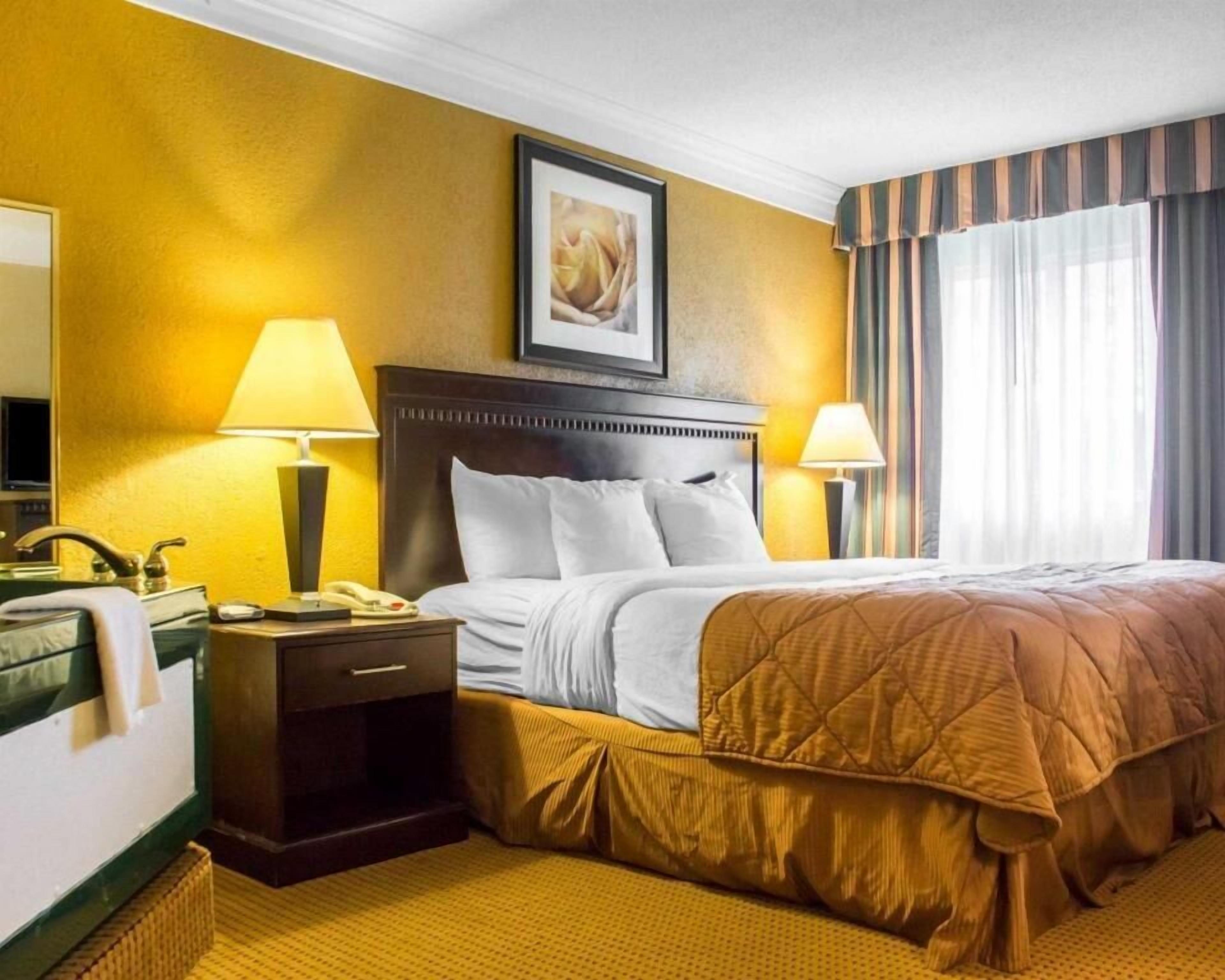 Premium bedding, desk, laptop workspace, iron/ironing board