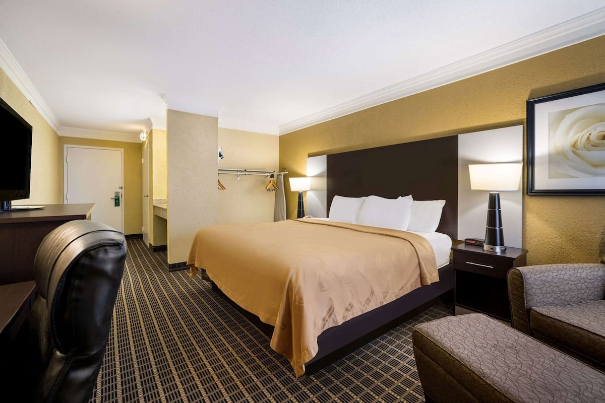 Premium bedding, desk, laptop workspace, iron/ironing board