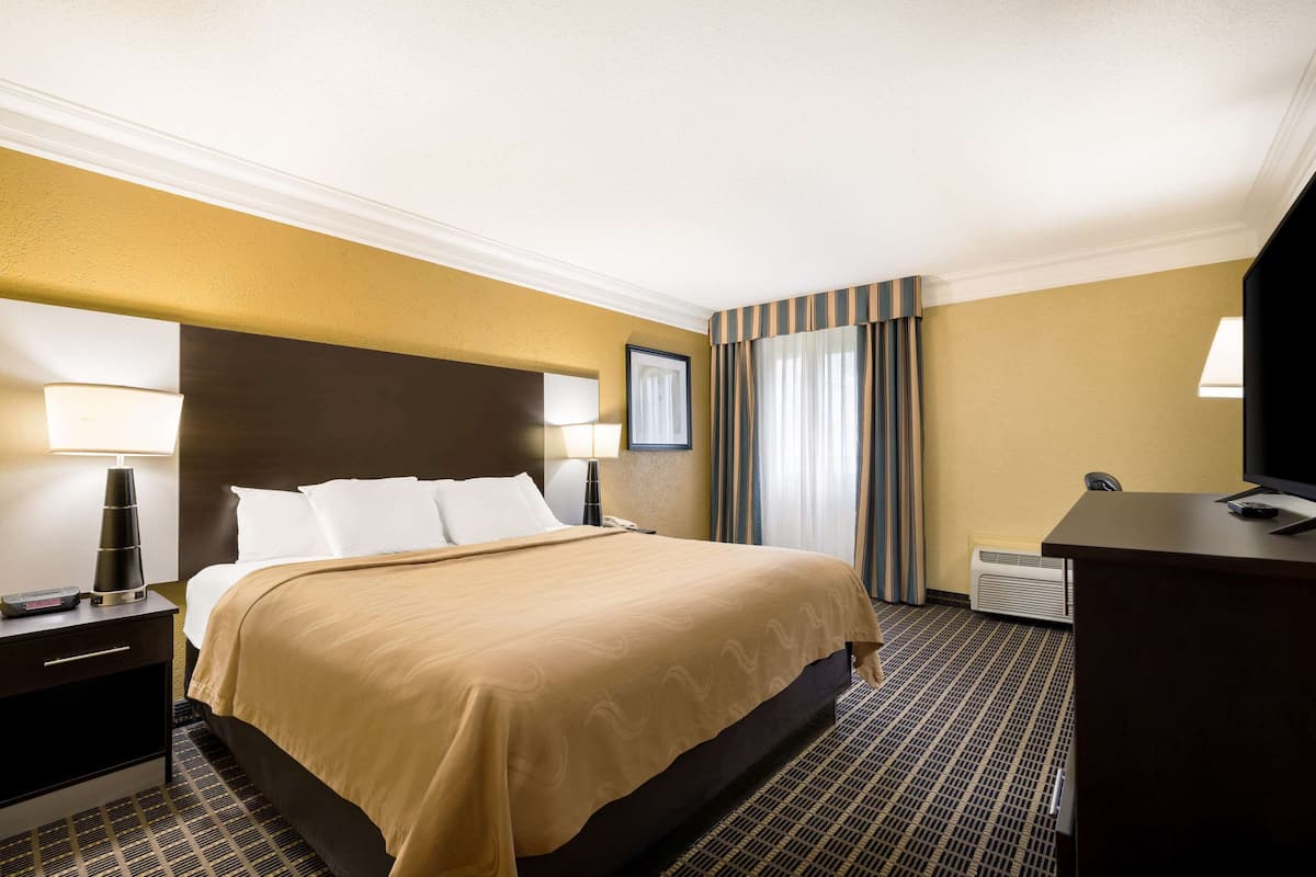 Premium bedding, desk, laptop workspace, iron/ironing board