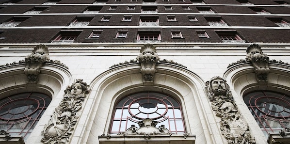 A building facade with ornate architectural details, including sculpted decorations and arched windows. - The Adolphus, Autograph Collection (Dallas)