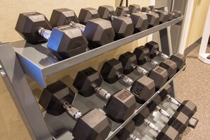 A rack of black dumbbells with weight markings, arranged on a metal stand. - Holiday Inn Express Mountain View - S Palo Alto by IHG (Mountain View)
