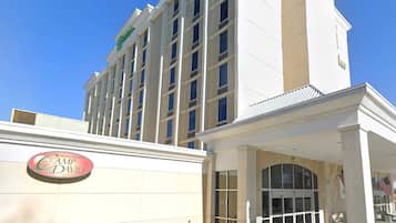 A hotel with a prominent sign for 'Camp David' and a large entrance with a covered area.