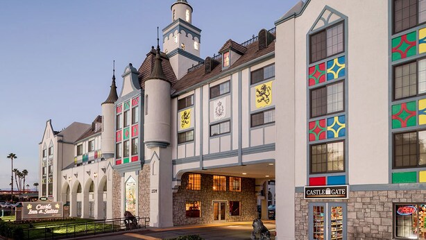 A castle-themed building with a prominent tower, a sign for 'Castle Gate,' and a 'Castle Inn & Suites' sign. - Castle Inn and Suites (Anaheim)